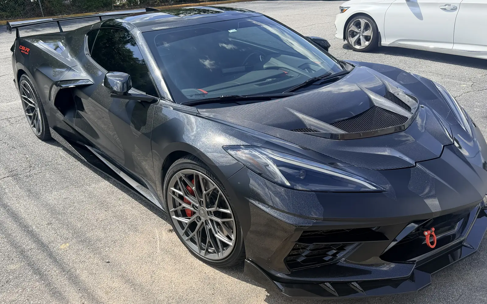 The same C8 Corvette after a gray camo wrap
