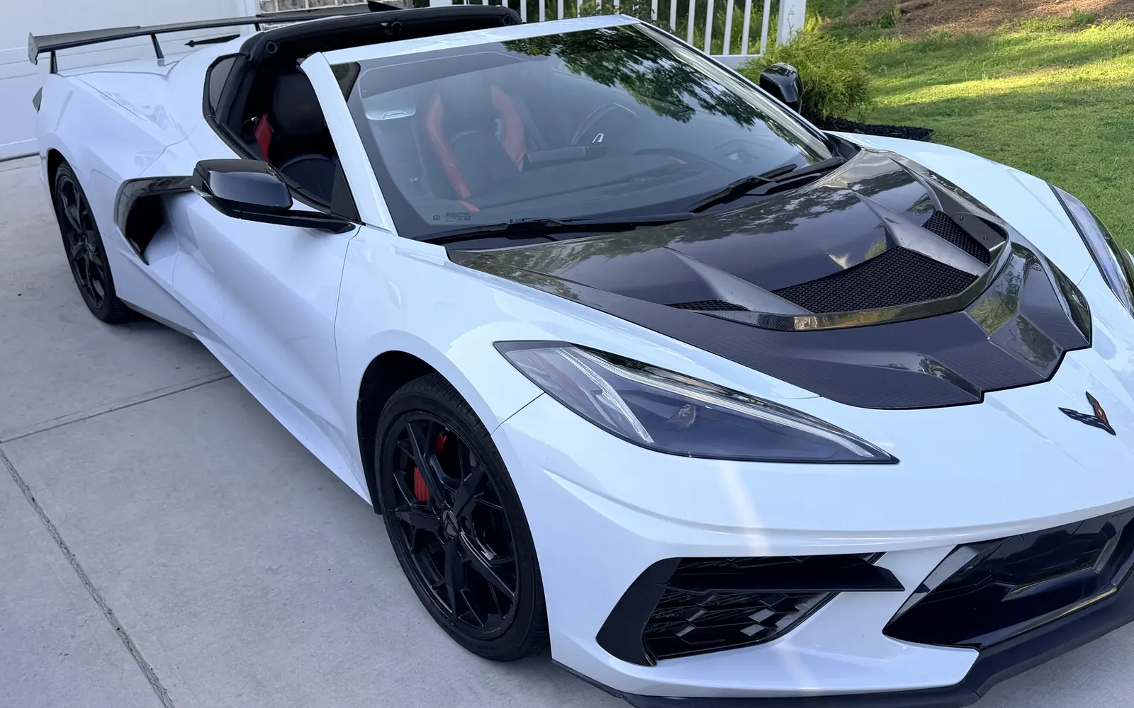C8 Corvette before the wrap, in factory white with a black hood
